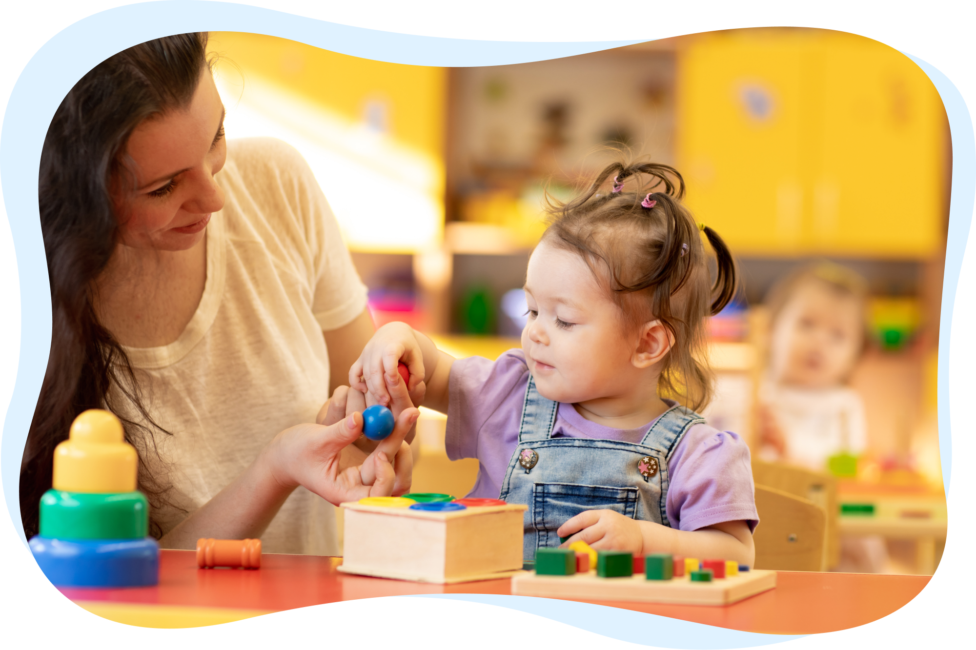 A teacher assisting a young girl with a wooden puzzle at a table.