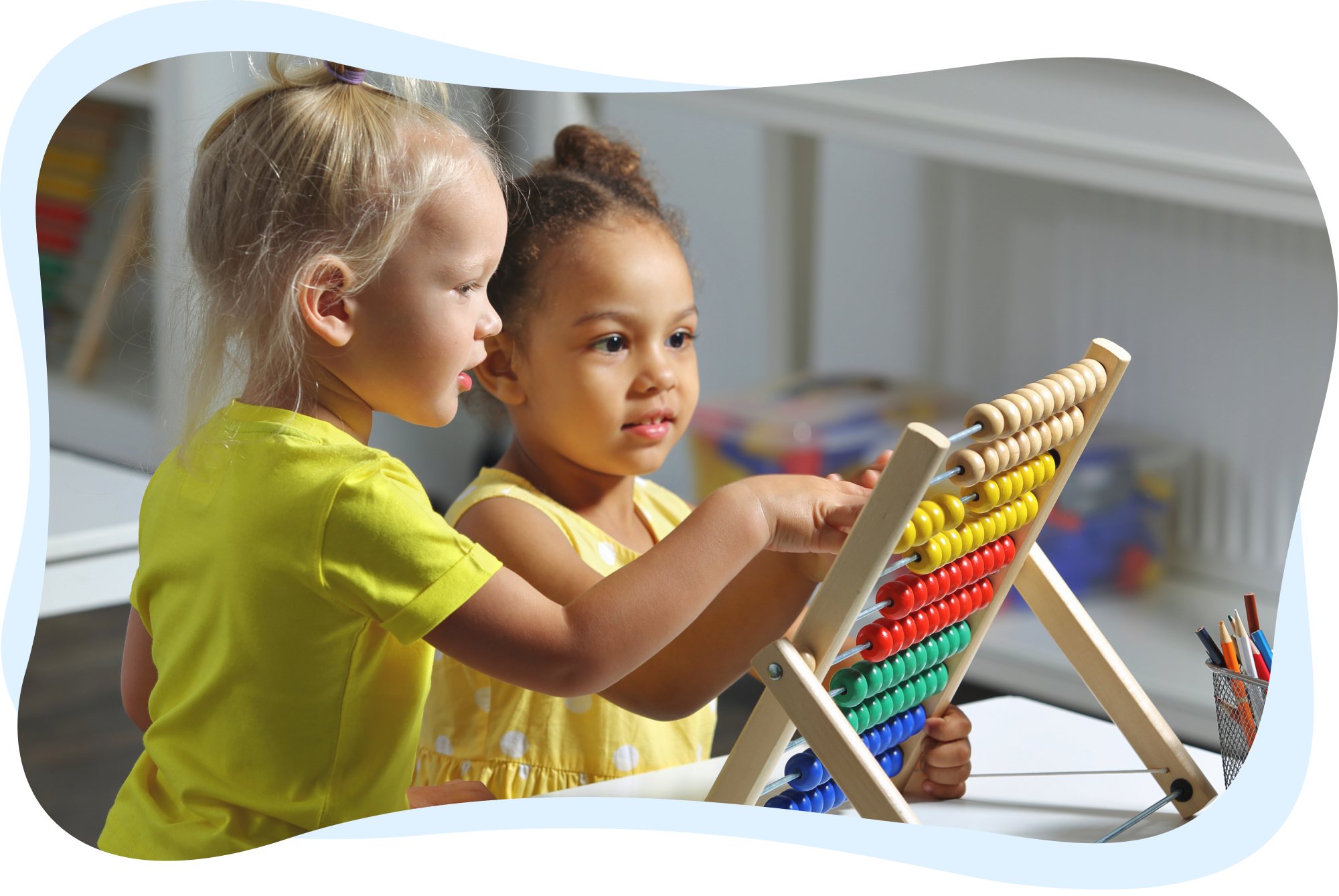 Two young girls playing with a colorful abacus at a table.