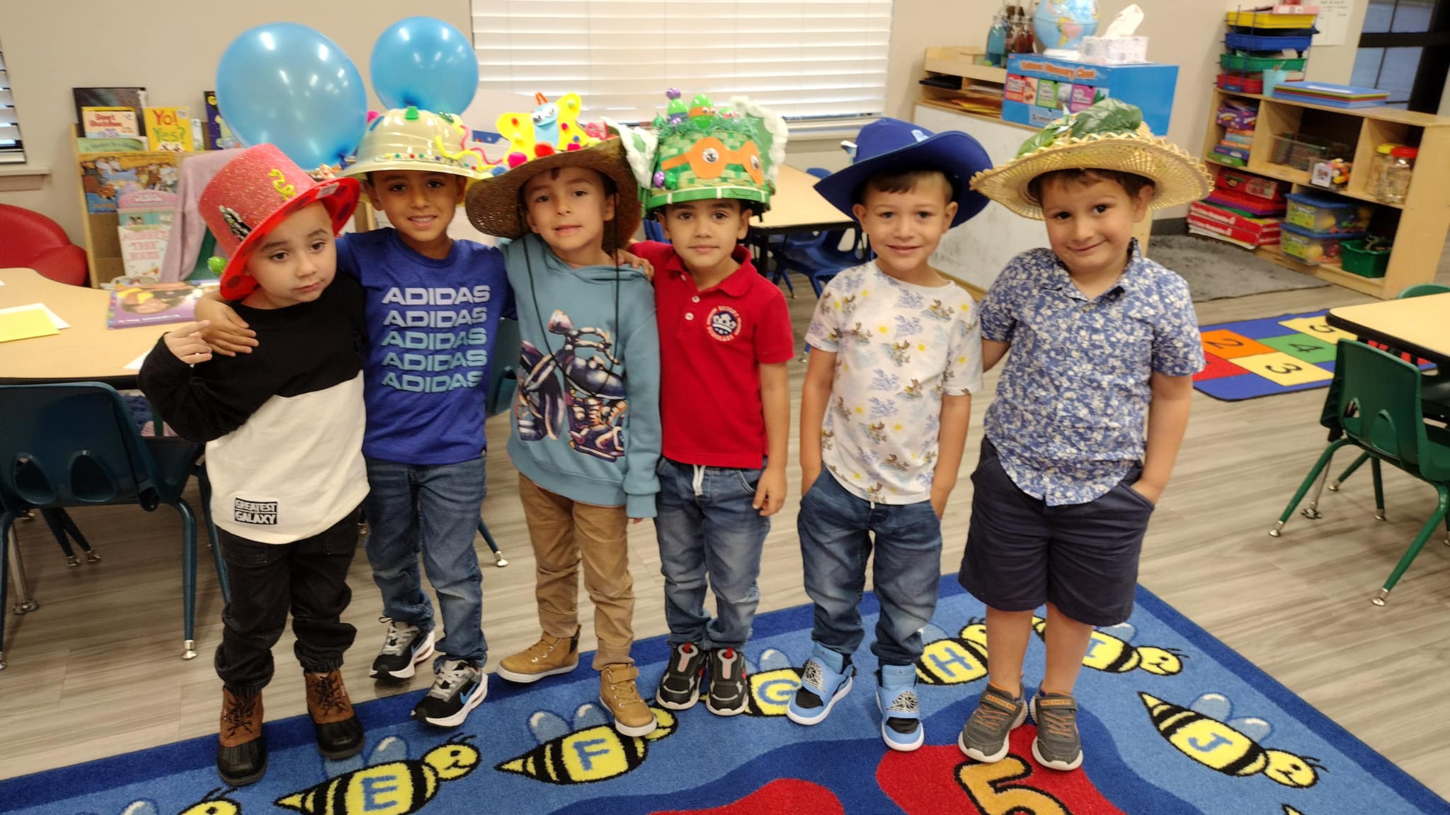 A group of Pre-Scholars lined up wearing hats for Hat Day.